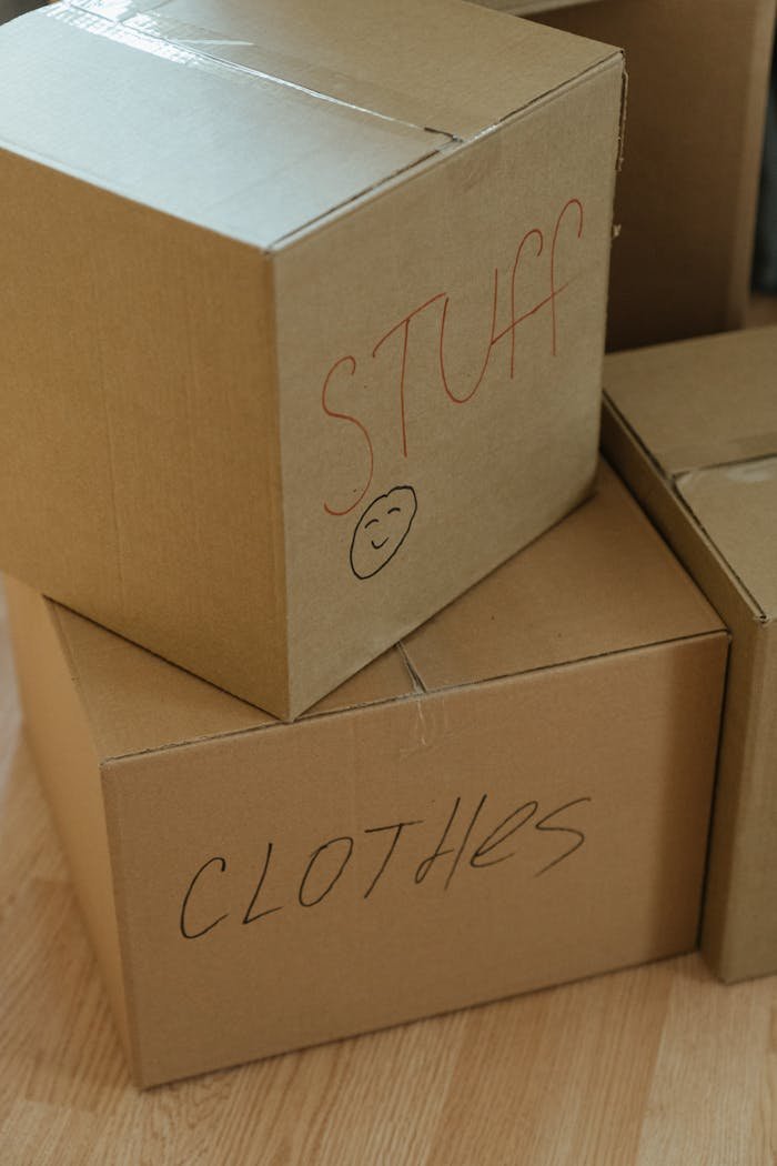 services-01 A collection of labeled cardboard boxes ready for moving day.